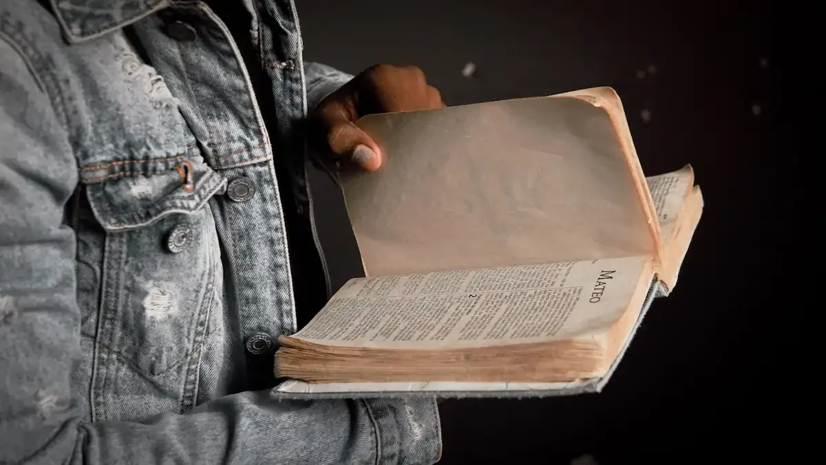 Hands holding an open Bible